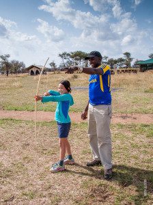 archery at camp on family safari