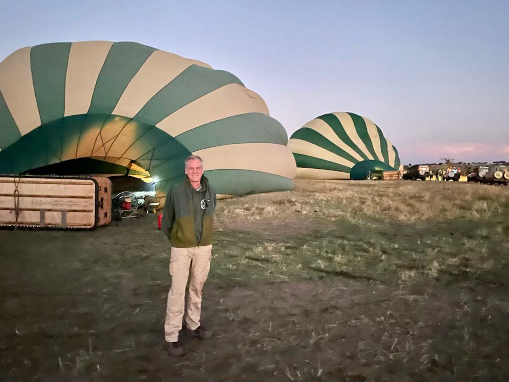 thomson guest prepares for hot air balloon ride in serengeti
