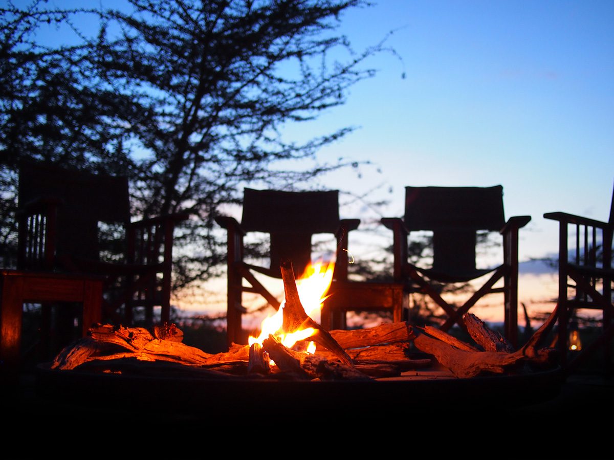 camp fire at night in camp in serengeti