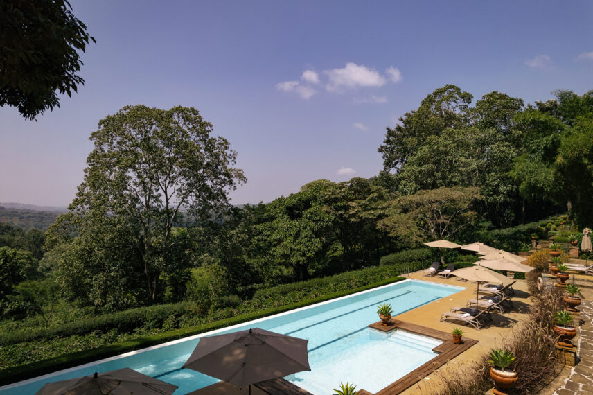 pool at gibbs farm with view of verdant ngorongoro slopes