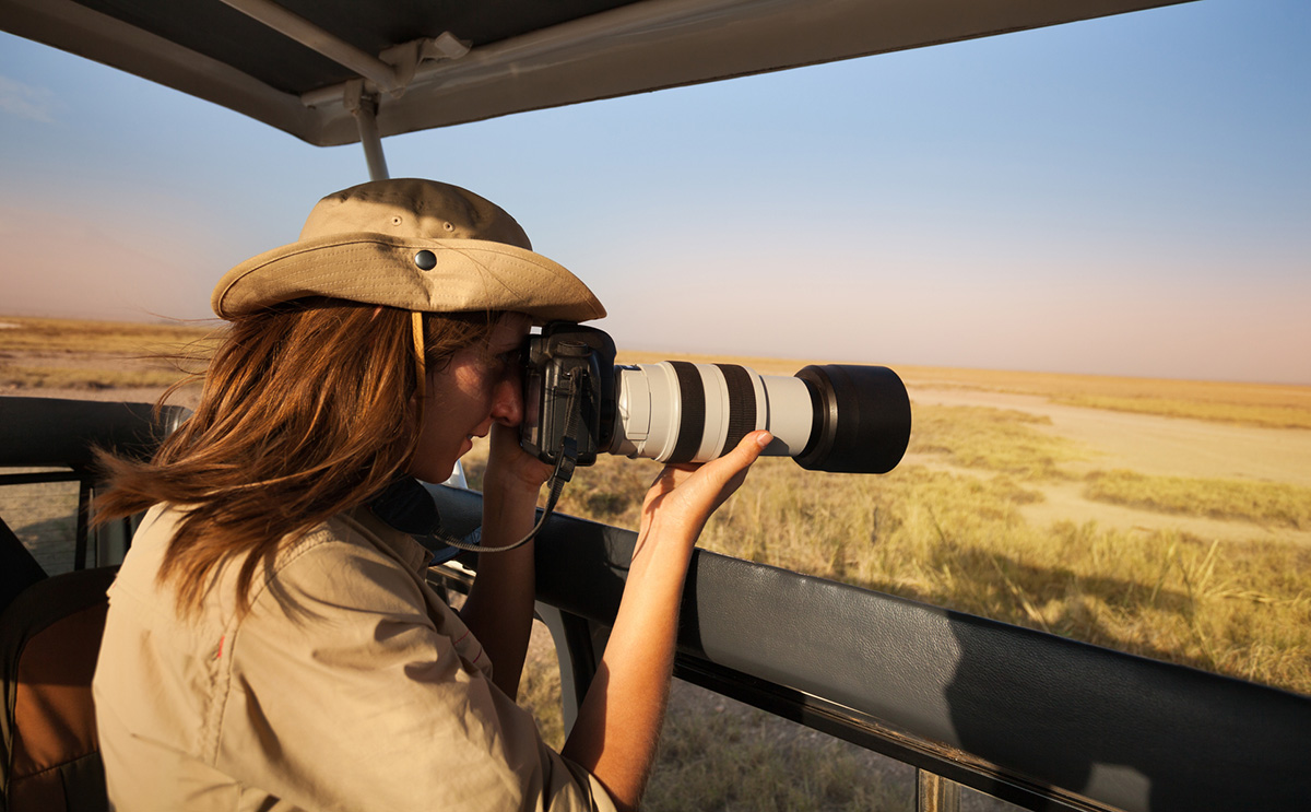 woman using DSLR camera on safari