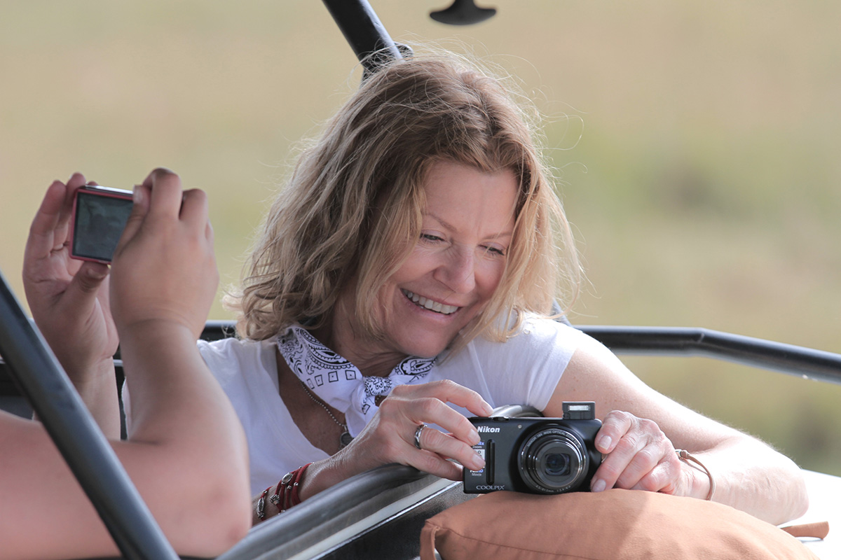 woman photographing wildlife in serengeti