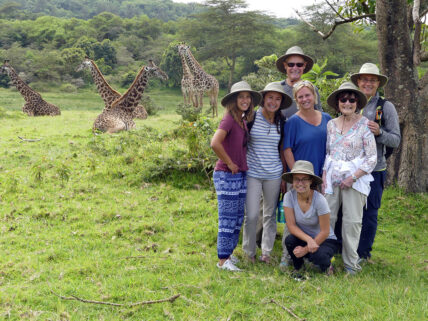 family with a giraffe on a thomson safari