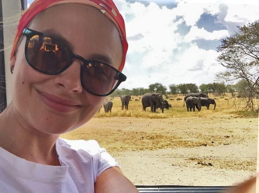 teen safari guest takes selfie with elephants in serengeti