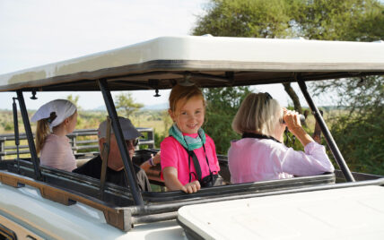 sunny in landrover with her grandparents and sister