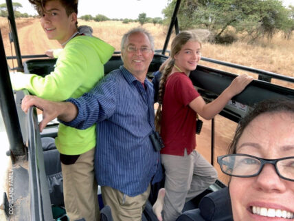 family in thomson landrover on safari in tanzania