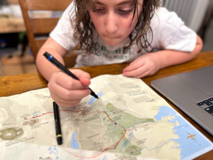 child with safari map for family trip to tanzania