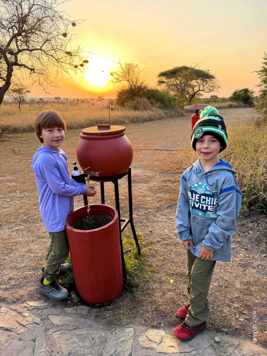 boys washing hands outside dining tent at thomson serengeti nyumba camp