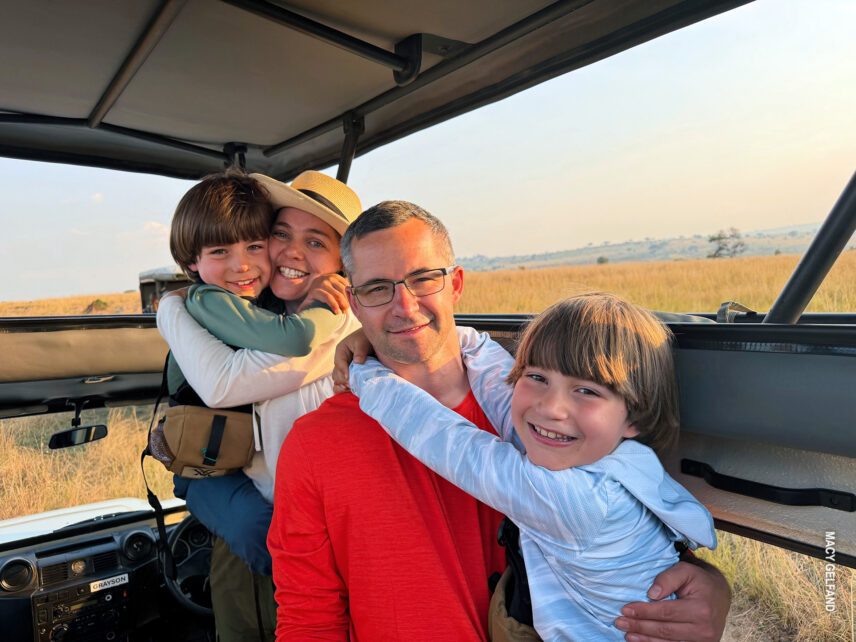 family posing for photo inside safari vehicle in serengeti on family safari