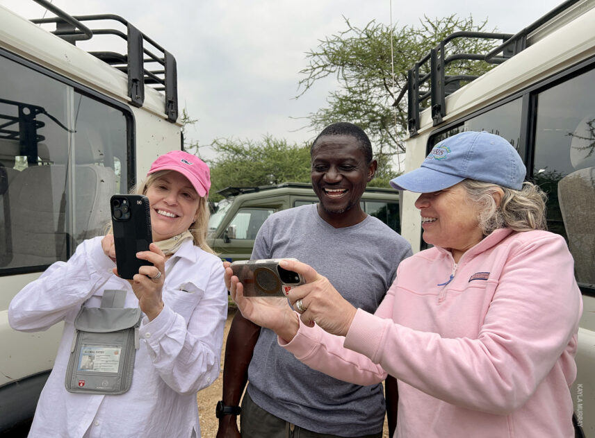 thomson safaris guests show guide grayson their photos from serengeti on iphones