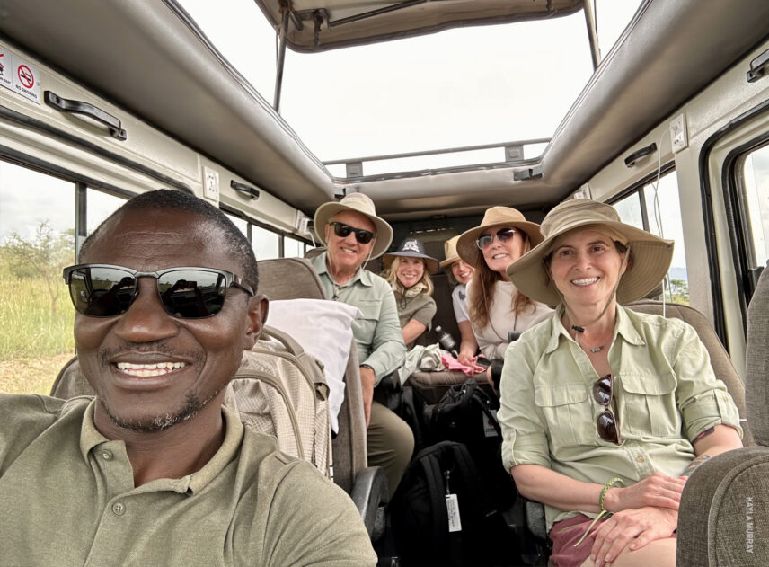 guide grayson takes a selfie with thomson safaris guests inside the vehicle